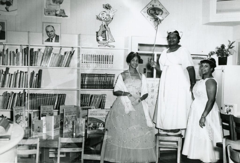 Photo of a faculty costume party in the library of Harrison Elementary School