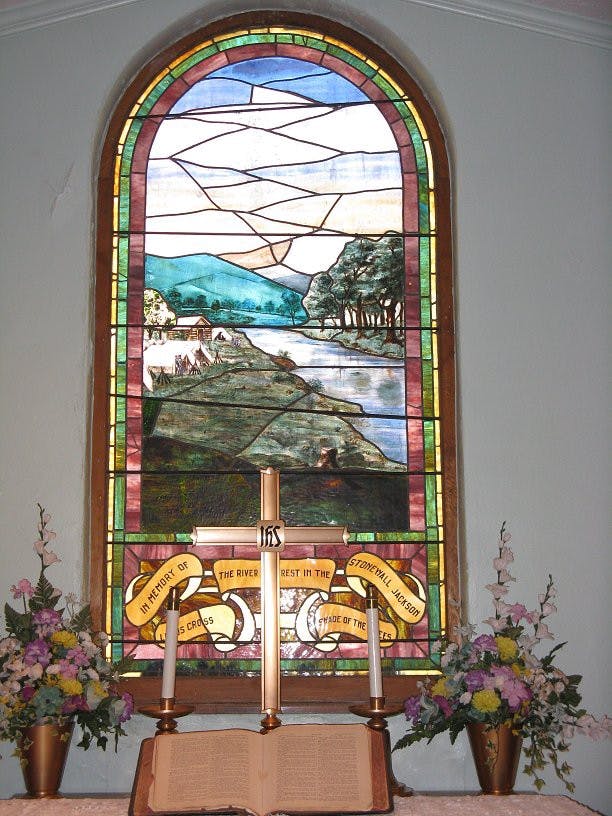 Stonewall Jackson memorial stained-glass window, showing a river flowing with a field on the left and a forest on the right
