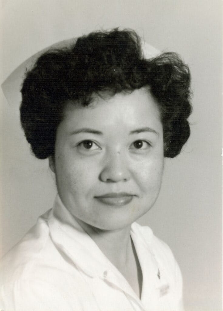A black and white photo of Kim Claytor in a nurses uniform