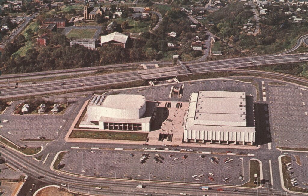An aerial photo of the Civic Center with 3 houses visibly still standing with the parking lot built around them